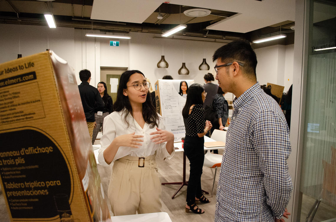 Mariam, left, a political science student, speaks with an employer from Carbon Upcycling Technologies.