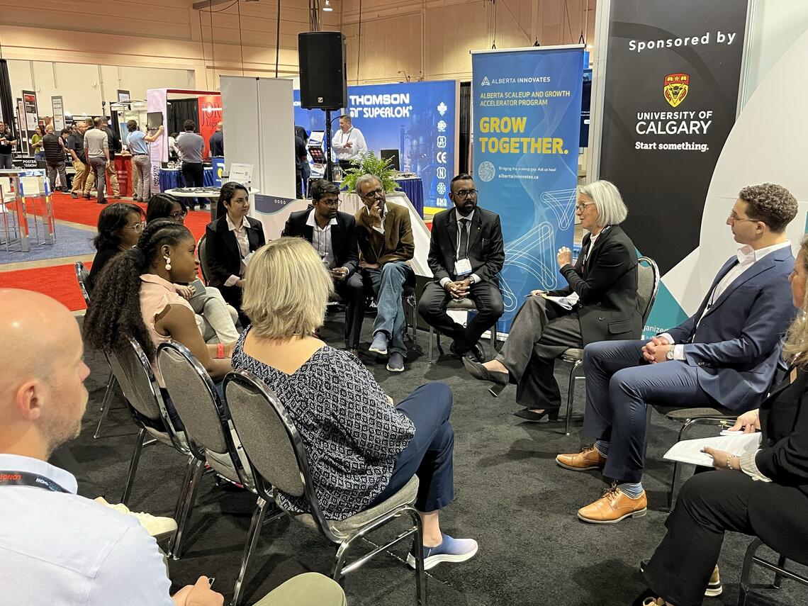 Martha Hall Findlay with a circle of people around her in chairs as she makes the welcoming remarks at the Plug and Play Innovation Zone