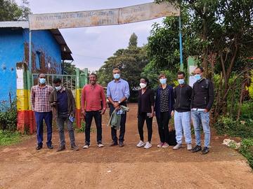 People standing on a road next to a clinic in Ethiopia. 