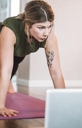 woman working out in front of laptop