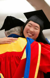 The first Richard and Lois Haskayne Legacy Scholarship recipient, Emily Chen, hugs Dick Haskayne at convocation.