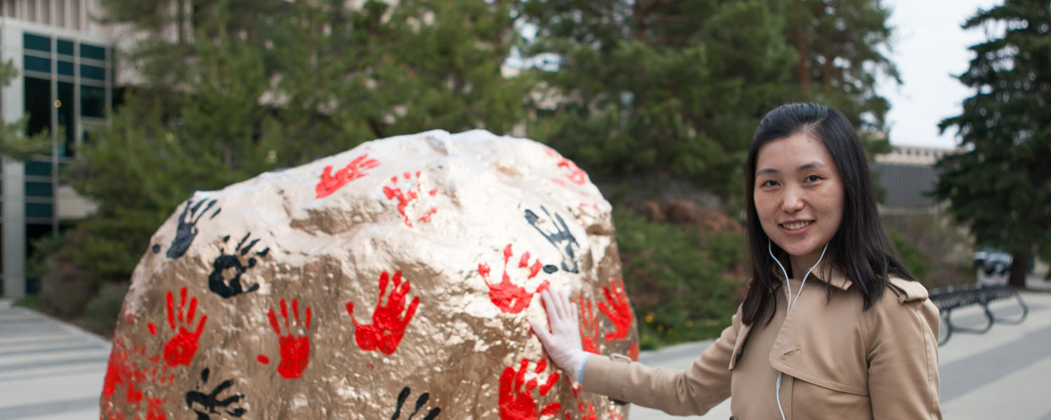 Back to touch the rock