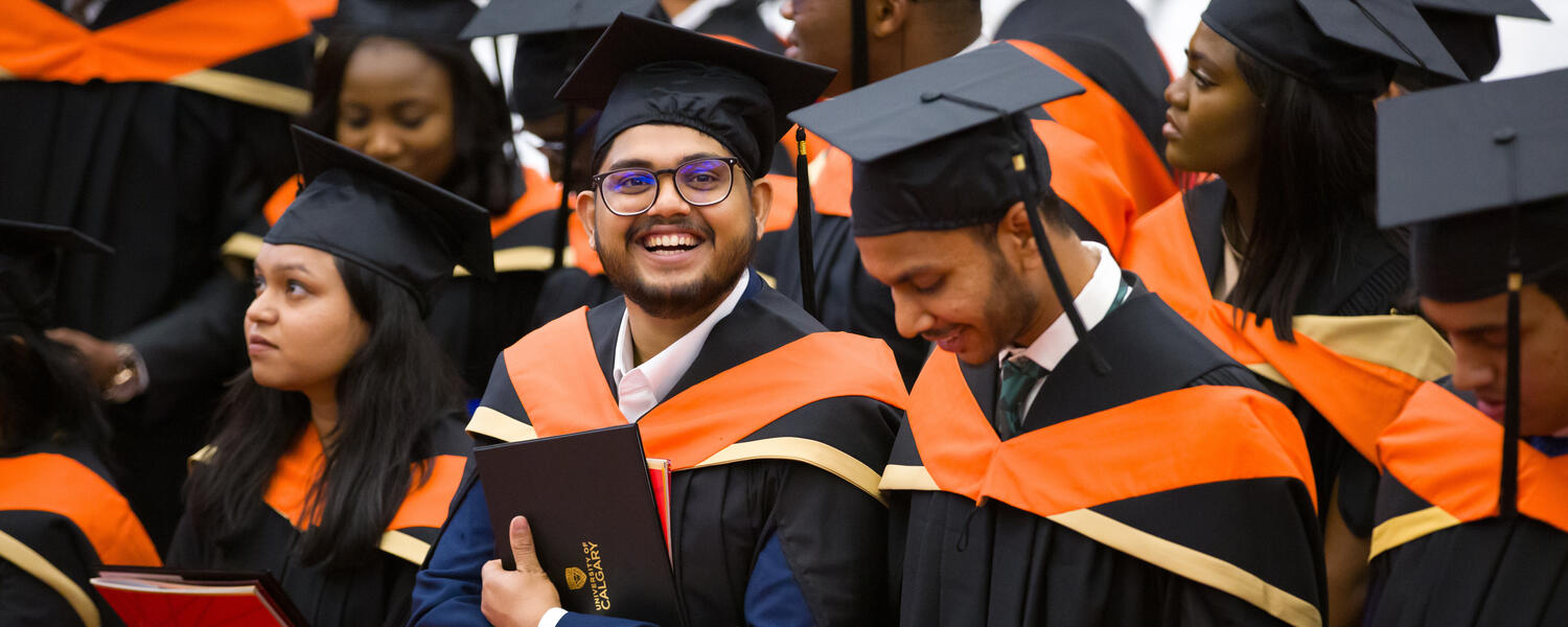 male student at convocation 2024 smiling at the camera