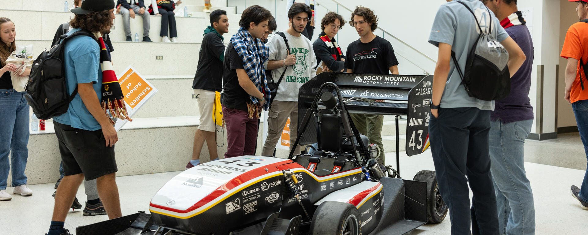 Schulich students and a race car