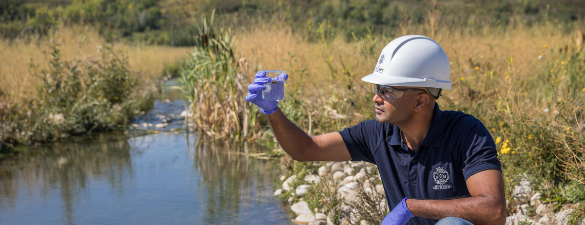 Student looking at water quality Student looking at water quality