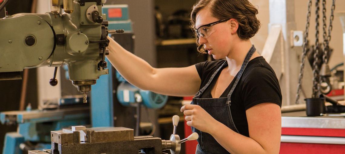 Woman engineer on drill press