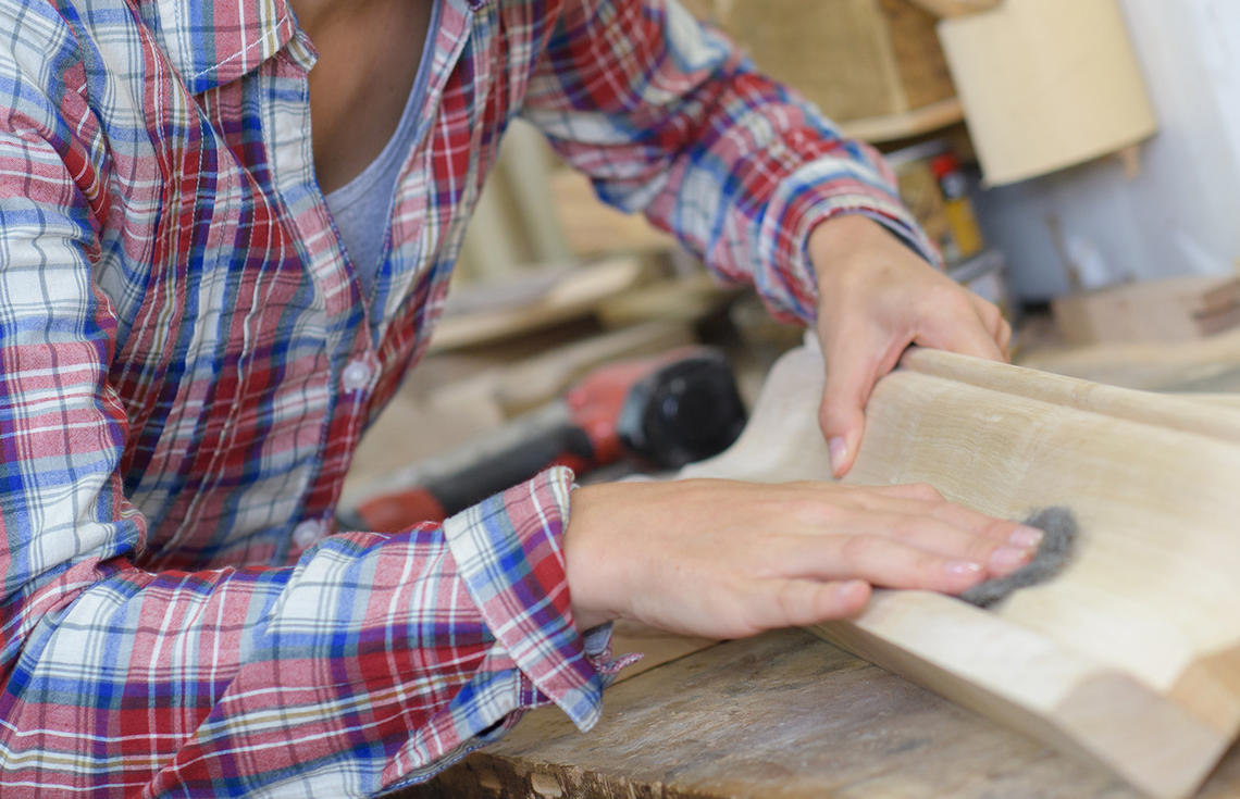 Woman sanding in woodshop