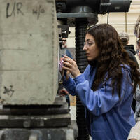female student measuring concrete in a lab