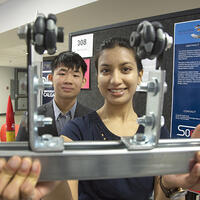 student holding up their project to the camera