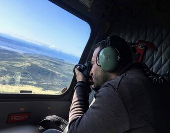 student on internship taking a photo from an airplane